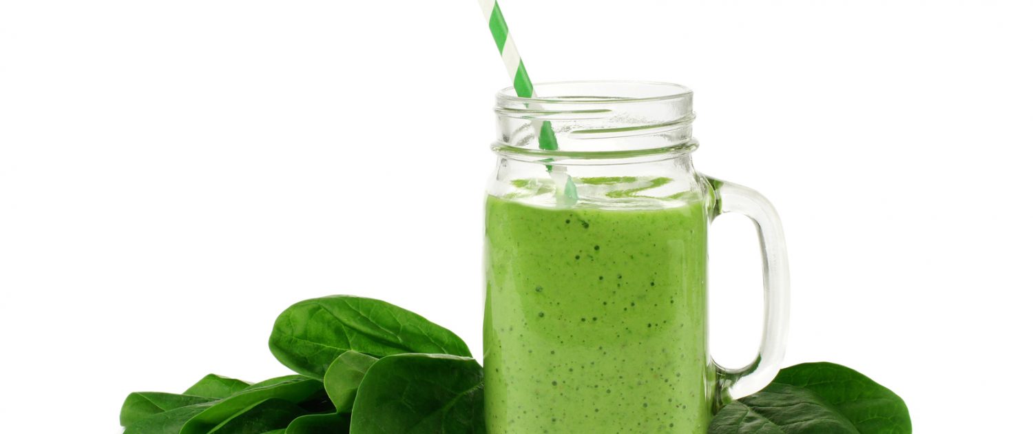 Healthy green smoothie with spinach in a jar mug isolated on white